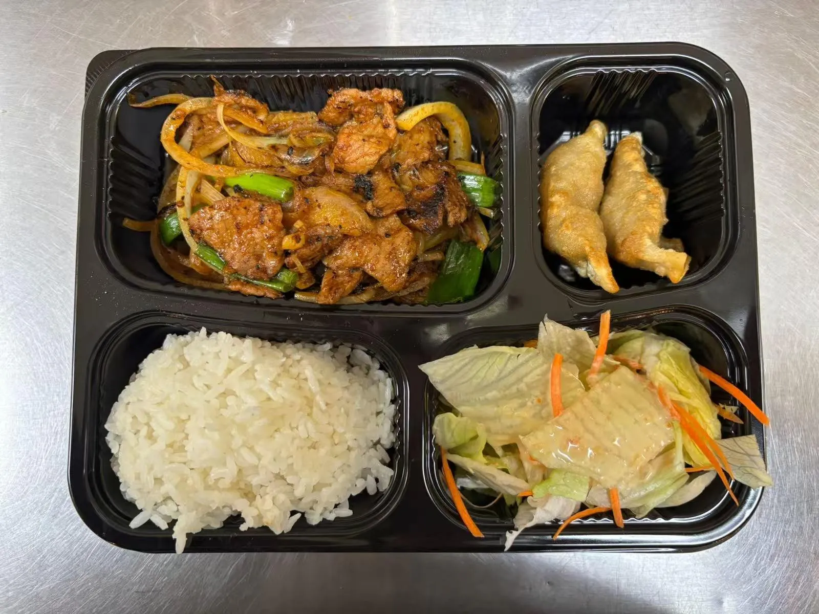Bento box with pork onion stir-fry at Zen Bento, a Asian Restaurant in Wichita