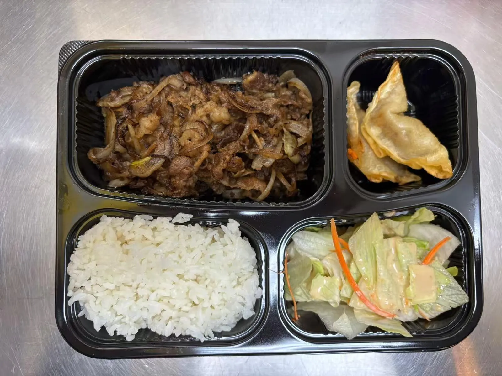 Bento box with beef onion stir-fry at Zen Bento, a Asian Restaurant in Wichita