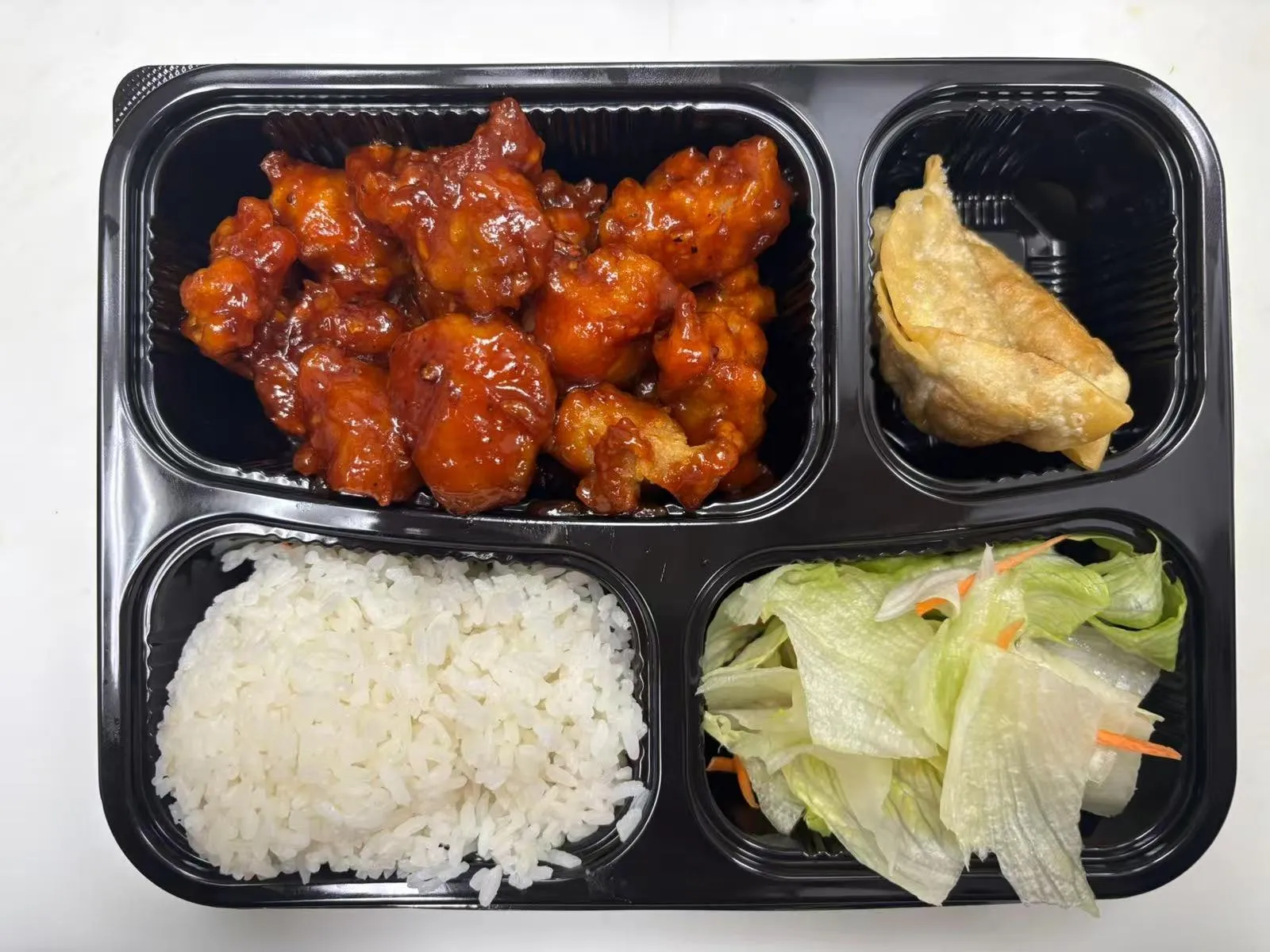 Bento box with orange chicken at Zen Bento, a Asian Restaurant in Wichita
