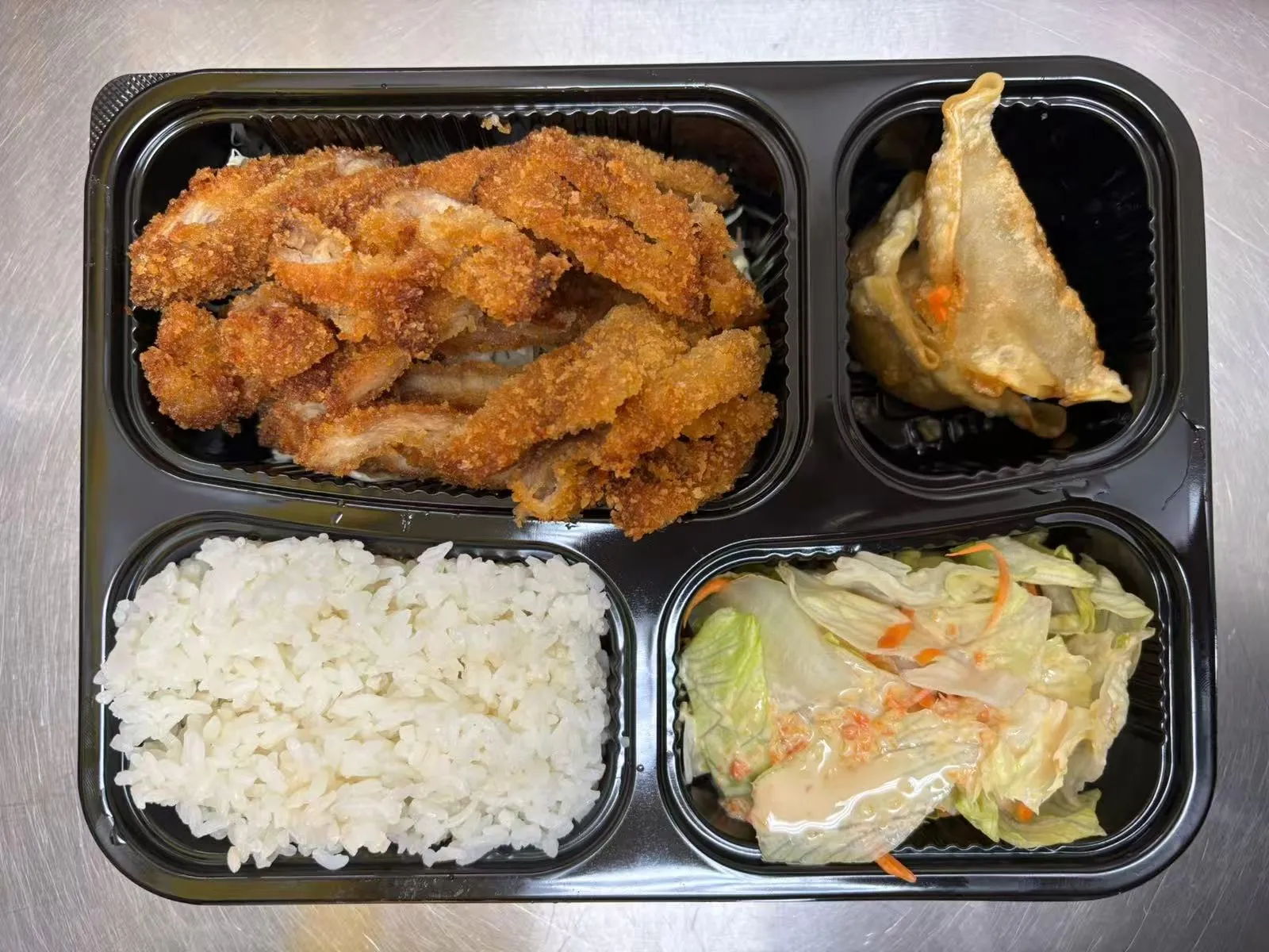 Bento box with crispy pork cutlet at Zen Bento, a Asian Restaurant in Wichita